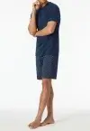 Short SCHIESSER men's pajama set in admiral blue featuring a solid V-neck top, patterned shorts, side pockets, and soft single jersey fabric.